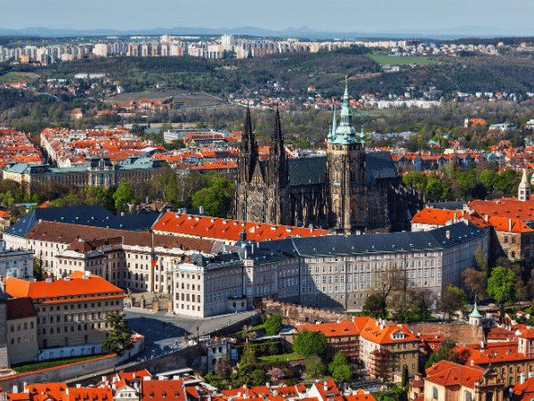 Aerial view of Prague Castle and St. Vitus Cathedral surrounded by red rooftops – DMC Czech Republic