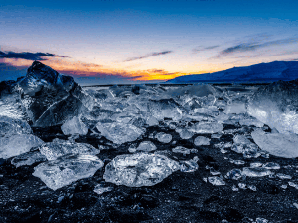 Icebergs washed ashore on Diamond Beach, showcasing the stunning natural beauty curated by a DMC in Iceland.