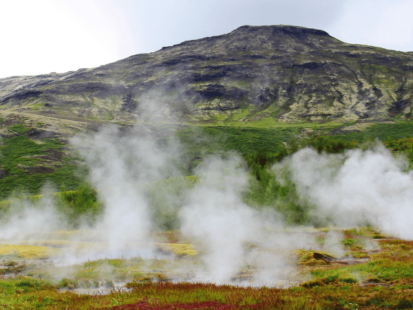 The Strokkur Geysir hot spring erupting, symbolizing the unique, powerful experiences managed by a DMC in Iceland.