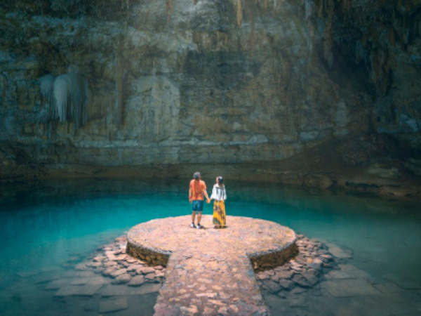 Cenotes in Mexico A couple takes in the breathtaking scenery of Cenote Suytun, a must-see attraction for couples in Yucatan.