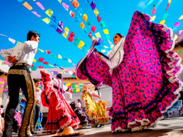 Mexican Culture Folk dancers in traditional dress perform a vibrant dance, a popular tourist attraction showcasing Mexico's heritage.