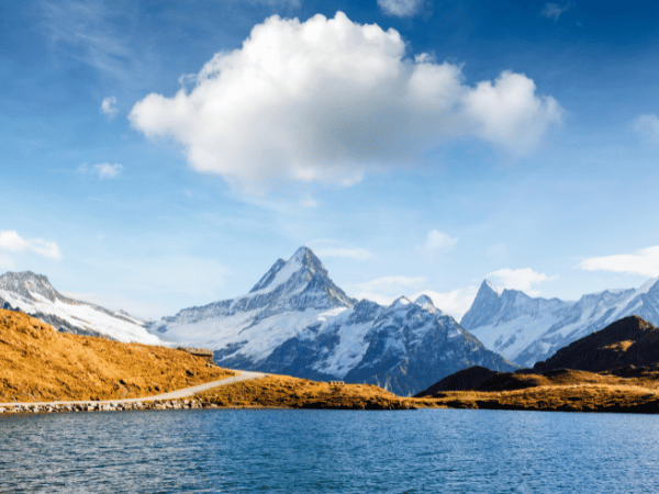 A group hiking near Bachalpsee Lake, showcasing outdoor team-building activities offered by a DMC in Switzerland
