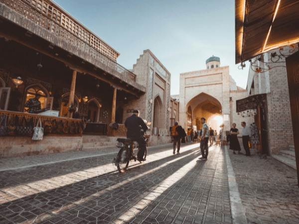 Tourists visiting the Poi Kalon mosque in Bukhara, Uzbekistan.